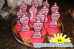geboorte flesjes op roze koek